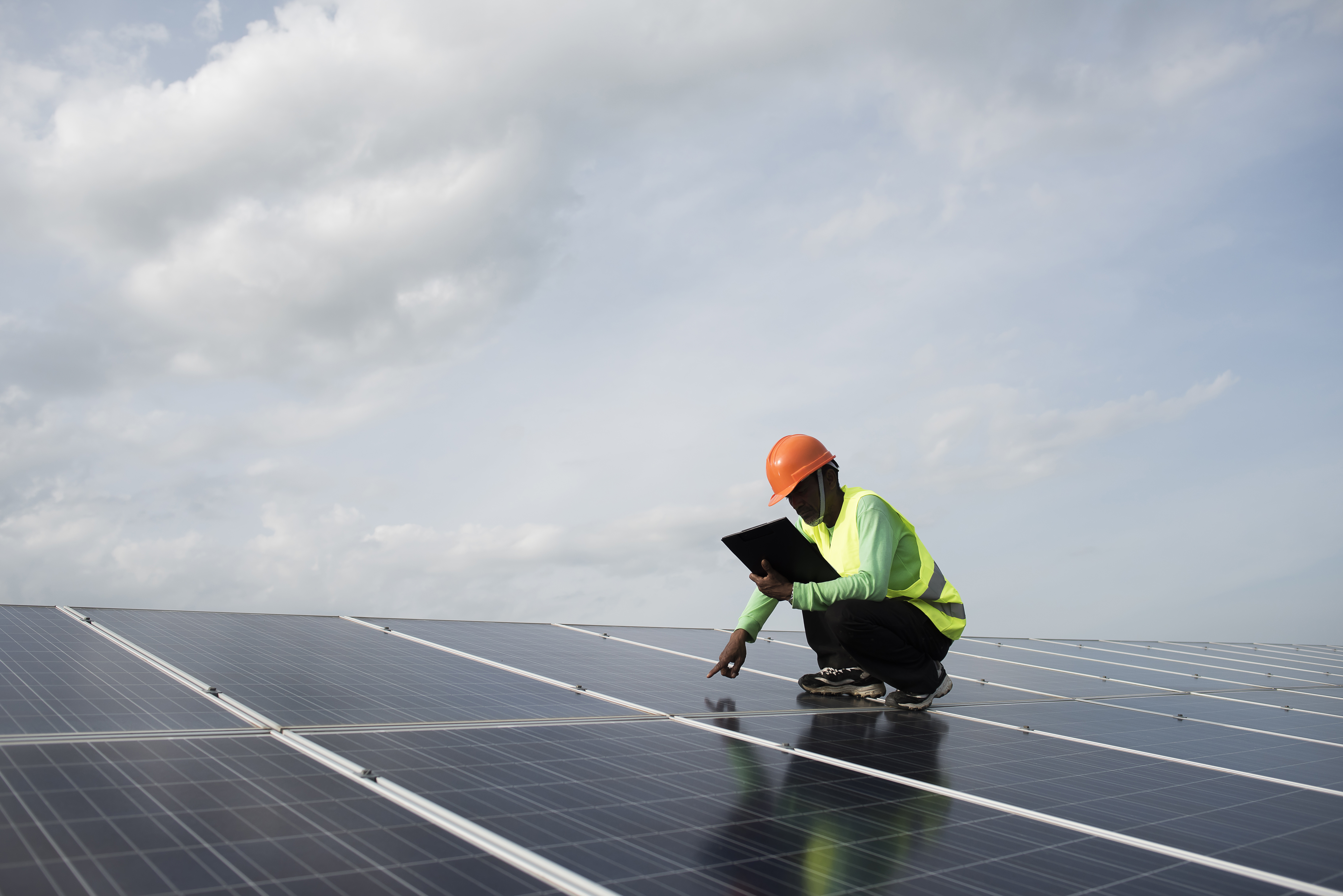 Solar technician inspecting panels